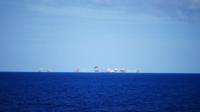 Central processing platform (cpp) in the middle of the ocean on sunny day - upstream industry