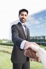 Successful arabic businessman or worker shaking hands with person