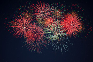 Sparkling red green yellow fireworks over starry sky