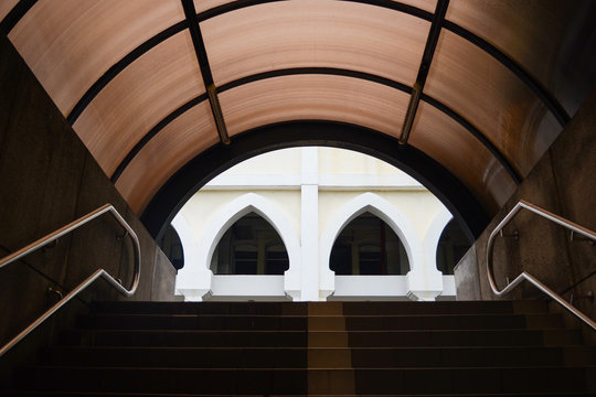 Fototapeta Modern Tunnel walk with stair and window of building background