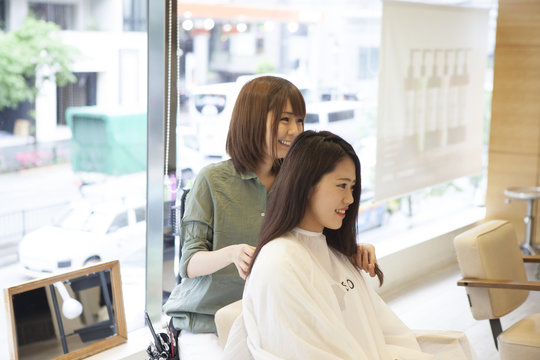 Women cut their hair with a hair salon