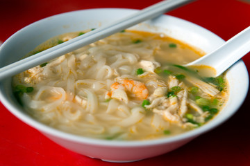 Rice noodle soup with shredded chicken