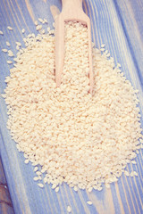 Vintage photo, Heap of sesame seeds on wooden plank
