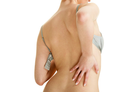 Attractive slim woman taking off grey bra