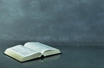 Bible on the old table. Beautiful background	