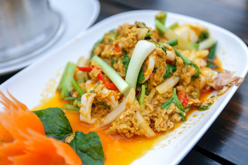 fried seafood with curry powder on white plate.