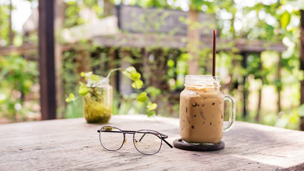 iced coffee and glasses on a wooden table.
