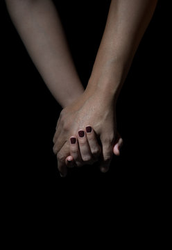 two hands of love people holding on a black background