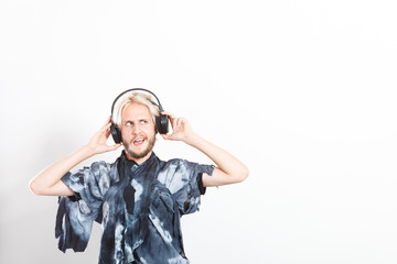 cool guy having fun listens to music in headphones