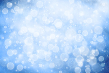 Abstract blue color bokeh with snowflake droplets. Fresh snowy New Year and Christmas background with copy space background.