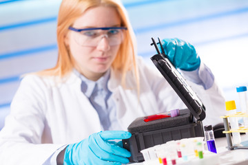 Female laboratory assistant with blood test for AIDS