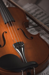 Fototapeta premium Old violin lying on the sheet of music, music concept