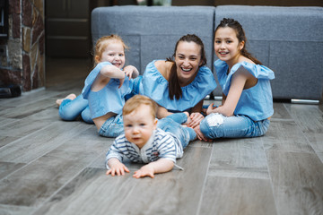 Mom, two daughters and a little son on the floor