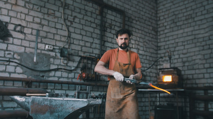 Blacksmith inspects the workpiece knife