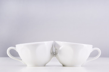Two white cups on a gray background. I love uou.