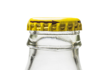 Neck of glass bottle from soda water with yellow metal stopper on white background