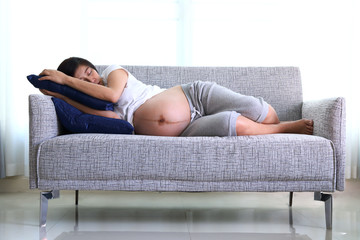 woman pregnant sleeping on sofa furniture in living room