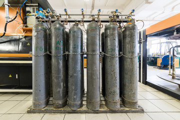 Rows of gray gas cylinders.