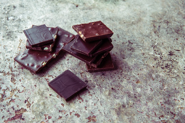 Dark chocolate stack with hazelnuts. Sweet dessert