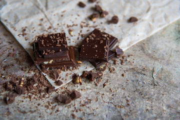 Dark chocolate stack with hazelnuts, selective focus