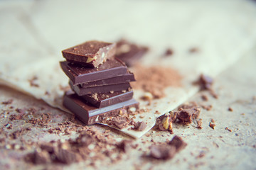Dark chocolate stack with hazelnuts, selective focus