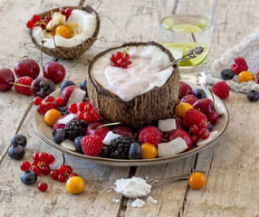 Coconut half with yogurt and healthy fruit salad