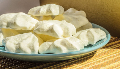 Zephyr and  marshmallows  on a blue plate