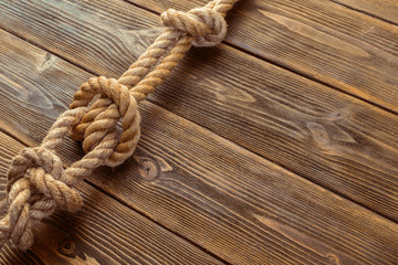 Fototapeta na wymiar Rope knot on wooden board