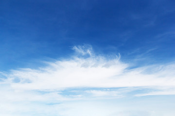 Naklejka na ściany i meble Soft white clouds against blue sky background and empty space for your design