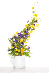 Violet, buttercups and dandelions yellow flowers in vase