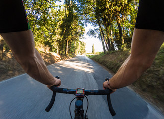 Cycling pov. Young adult man riding a racing bicycle on spring or summer