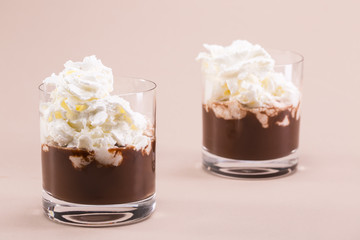 Two glasses of cocoa with whipped cream and marshmallows
