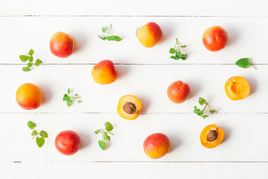 Apricot on white wooden background. Sliced apricot top view, flat lay