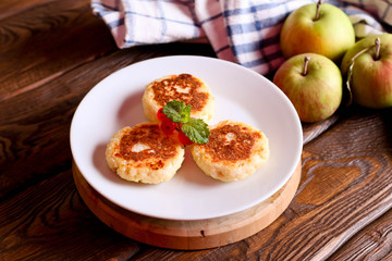 Cheese pancake, syrniki with red currant, decorated mint