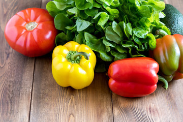 Fresh vegetables on wooden background Beautiful Yellow and red raw peppers Food for fasting days Ingredients for salad Diet or vegetarian food concept