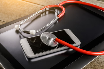 Repair and Service concept. Digital tablet and smartphone being diagnosed with a stethoscope