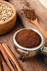 Freshly ground coffee beans in a metal filter for background