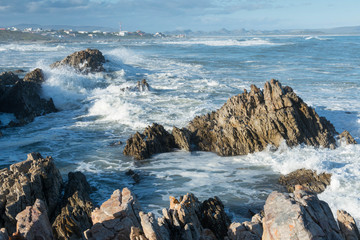 Rough waves crashing on rocks in Kleinbaai, South Africa