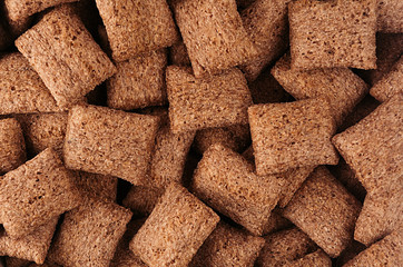 Chocolate pads corn flakes closeup background. Cereals texture.
