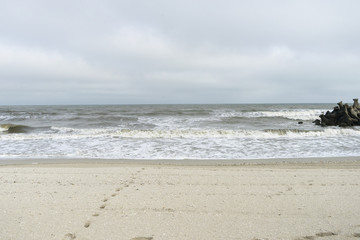 Seascape with breakwater irregularly arranged on seaside, at Gura Portitei, Romania