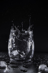 Glas with ice water splash