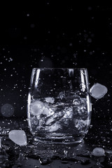 Glas with ice water splash