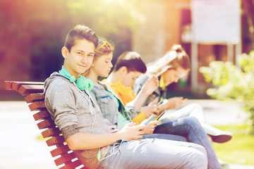 happy teenage boy with tablet pc and headphones