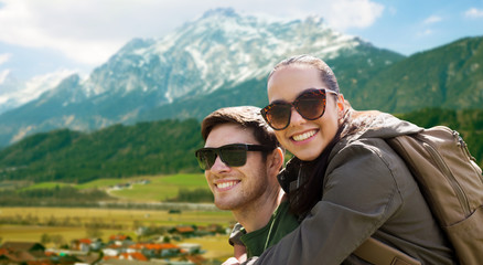 happy couple with backpacks traveling in highlands