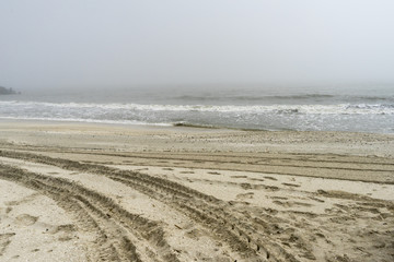 Footsteps in the sand at The Black Sea shore in Gura Portitei, Romania