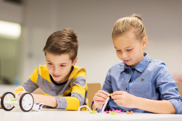 happy children building robots at robotics school