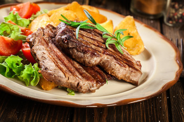 Succulent portions of grilled fillet mignon served with baked potatoes