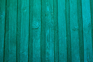Fototapeta premium Vintage wooden texture of an old fence painted green. Vertical texture on background