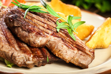 Succulent portions of grilled fillet mignon served with baked potatoes