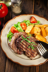 Succulent portions of grilled fillet mignon served with baked potatoes